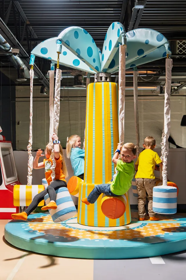 Kids riding the carousel spinner at Funrise